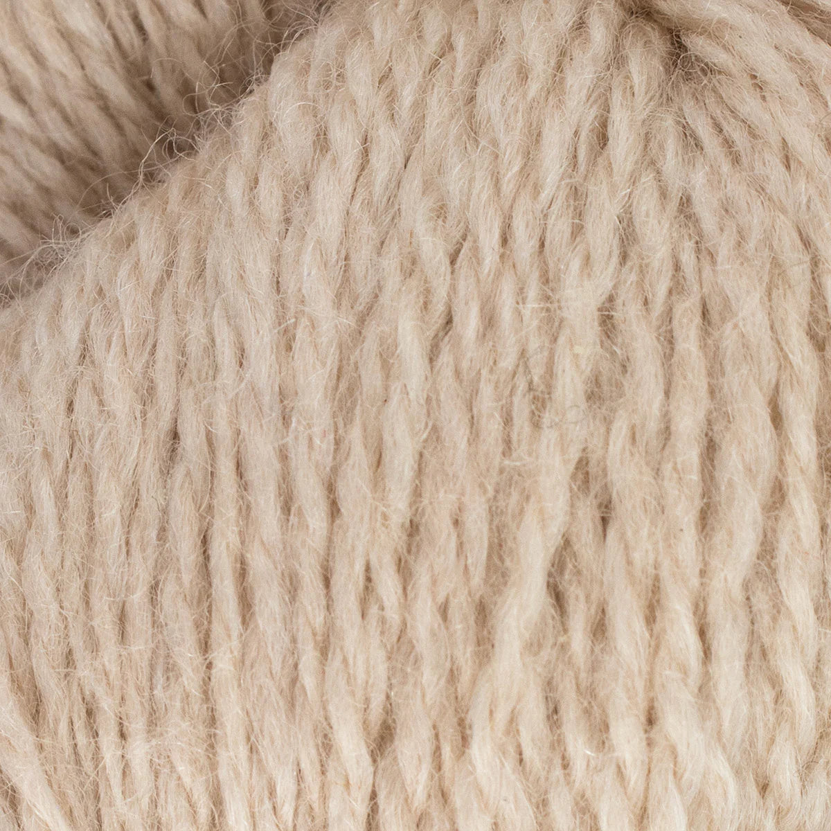 Close-up of beige yarn with a textured surface