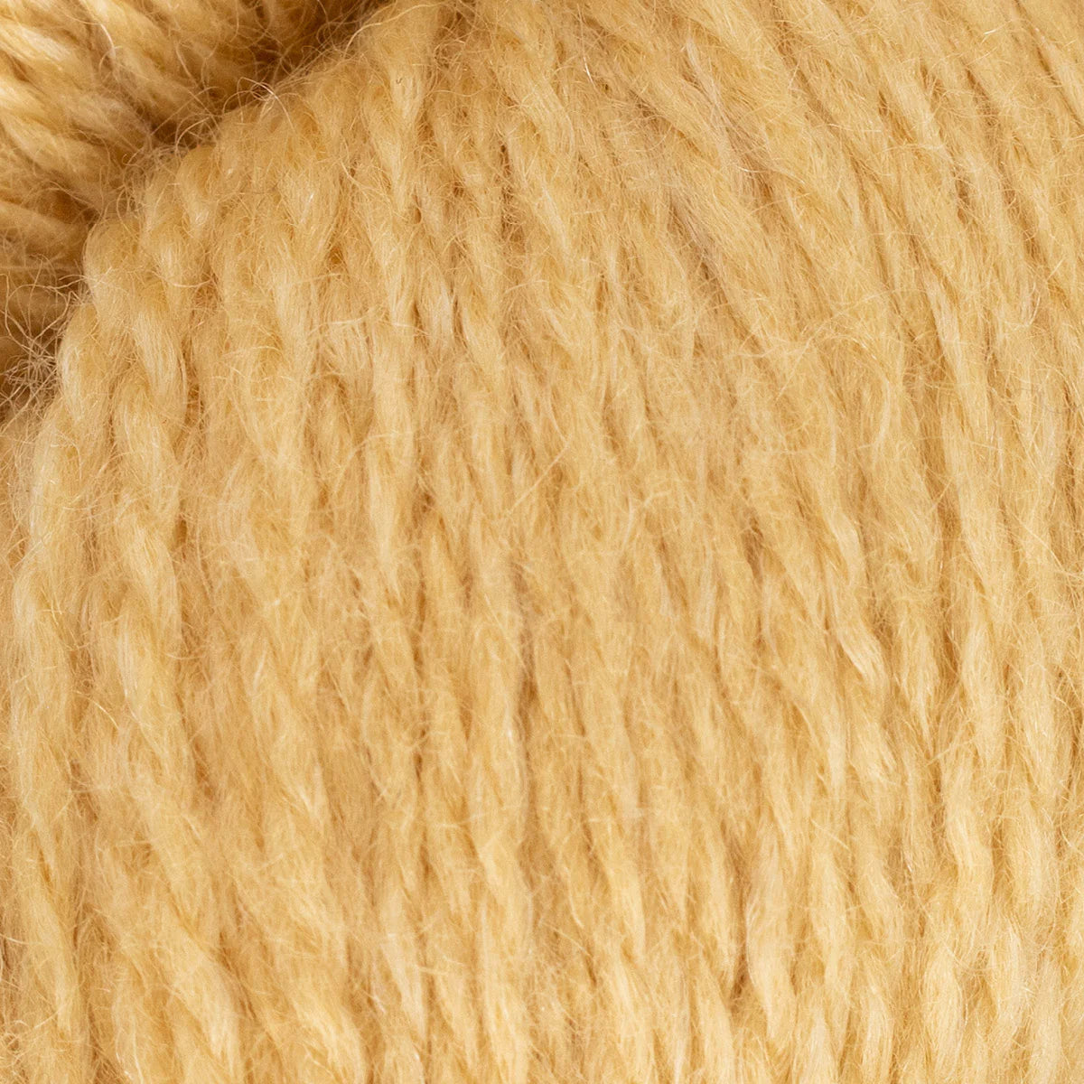 Close-up of beige yarn with a focus on texture
